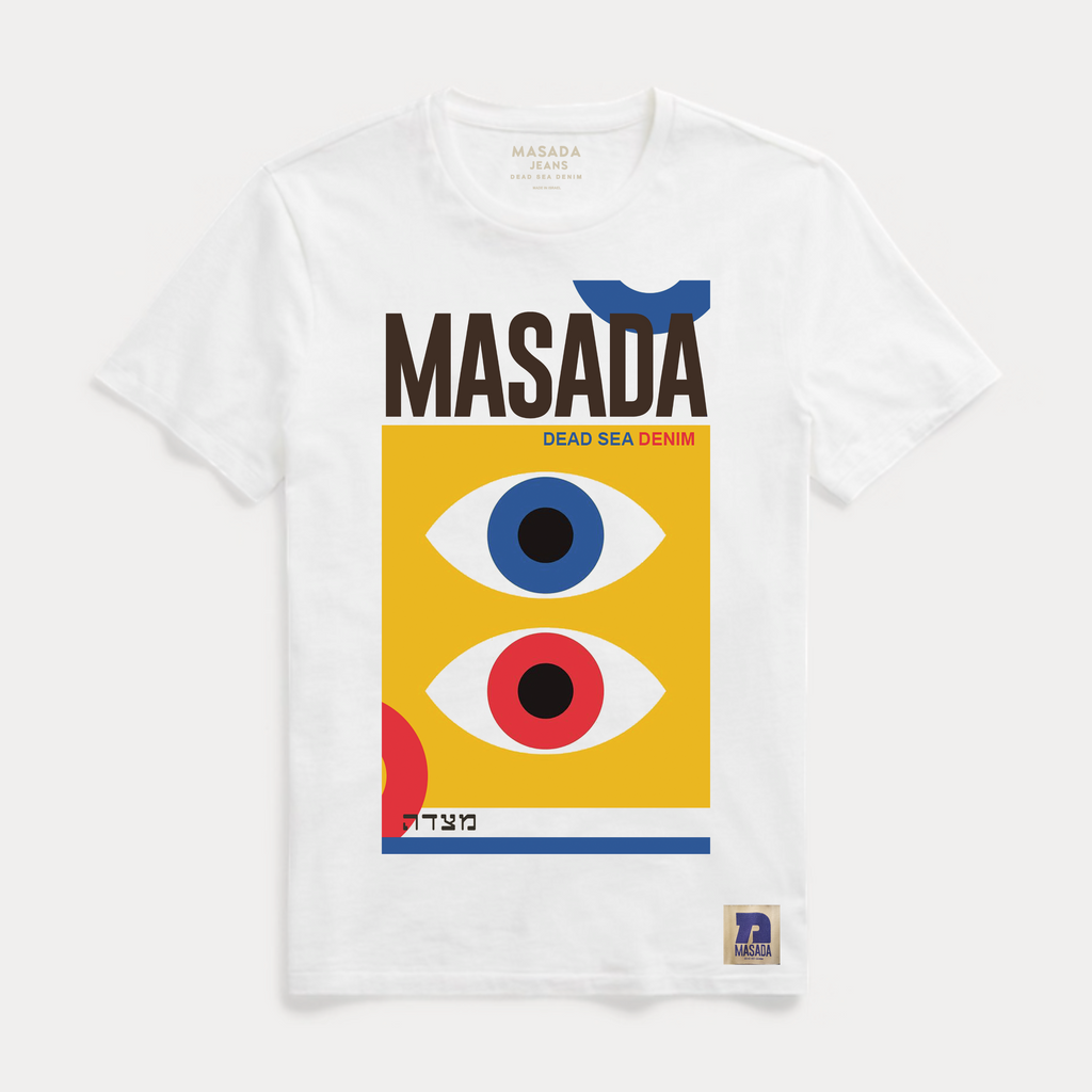 The HAYIN T-Shirt is a white premium cotton tee with bold “MASADA” above a yellow rectangle featuring one blue and one red eye. Below, smaller text reads Dead Sea Denim and Hebrew letters, with abstract shapes accenting this Masada Jeans design.