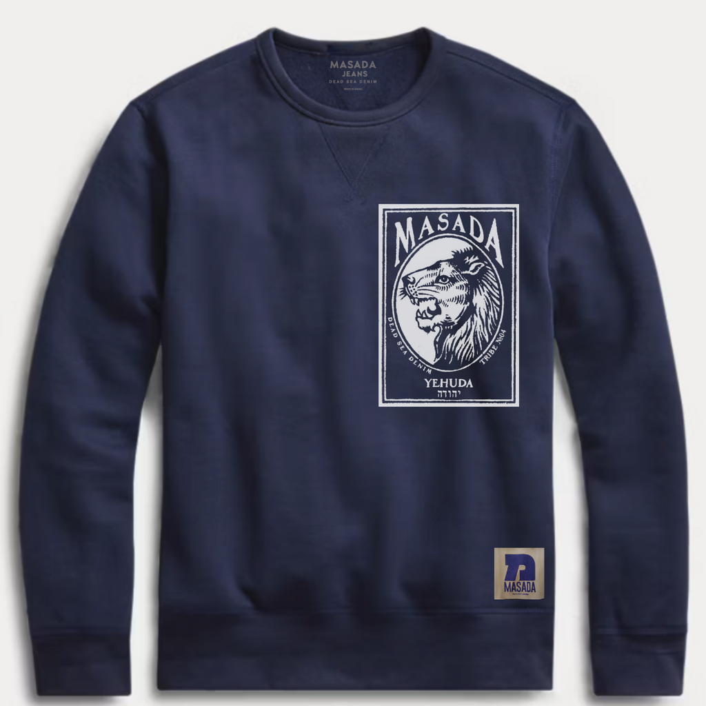 The Yehuda Navy Sweatshirt from the 12 Tribes Collection features a white rectangular lion’s head graphic with MASADA above and YEHUDA below, plus a small MASADA logo on the bottom hem.